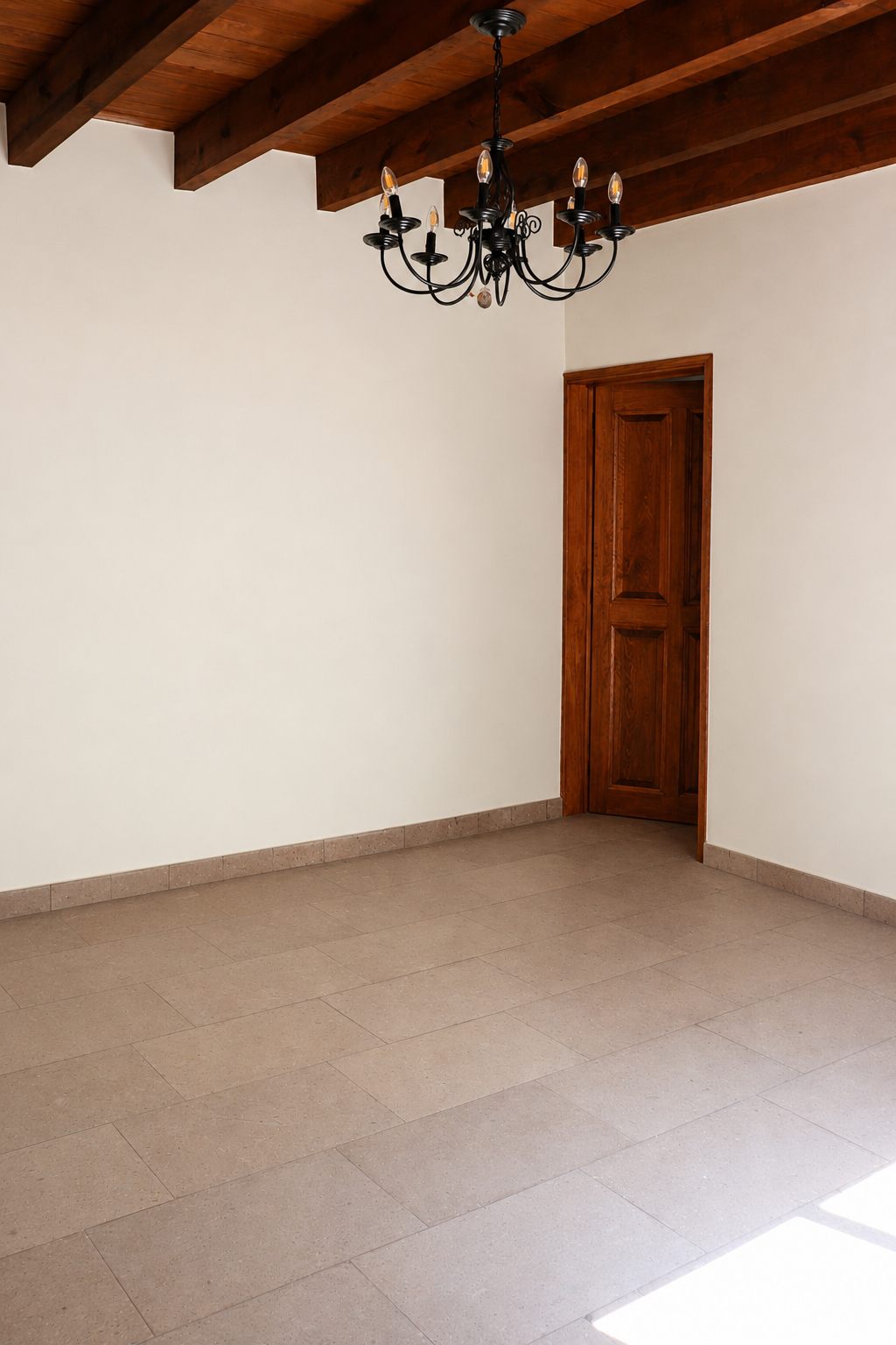 Bedroom with beamed ceiling and wrought-iron chandelier