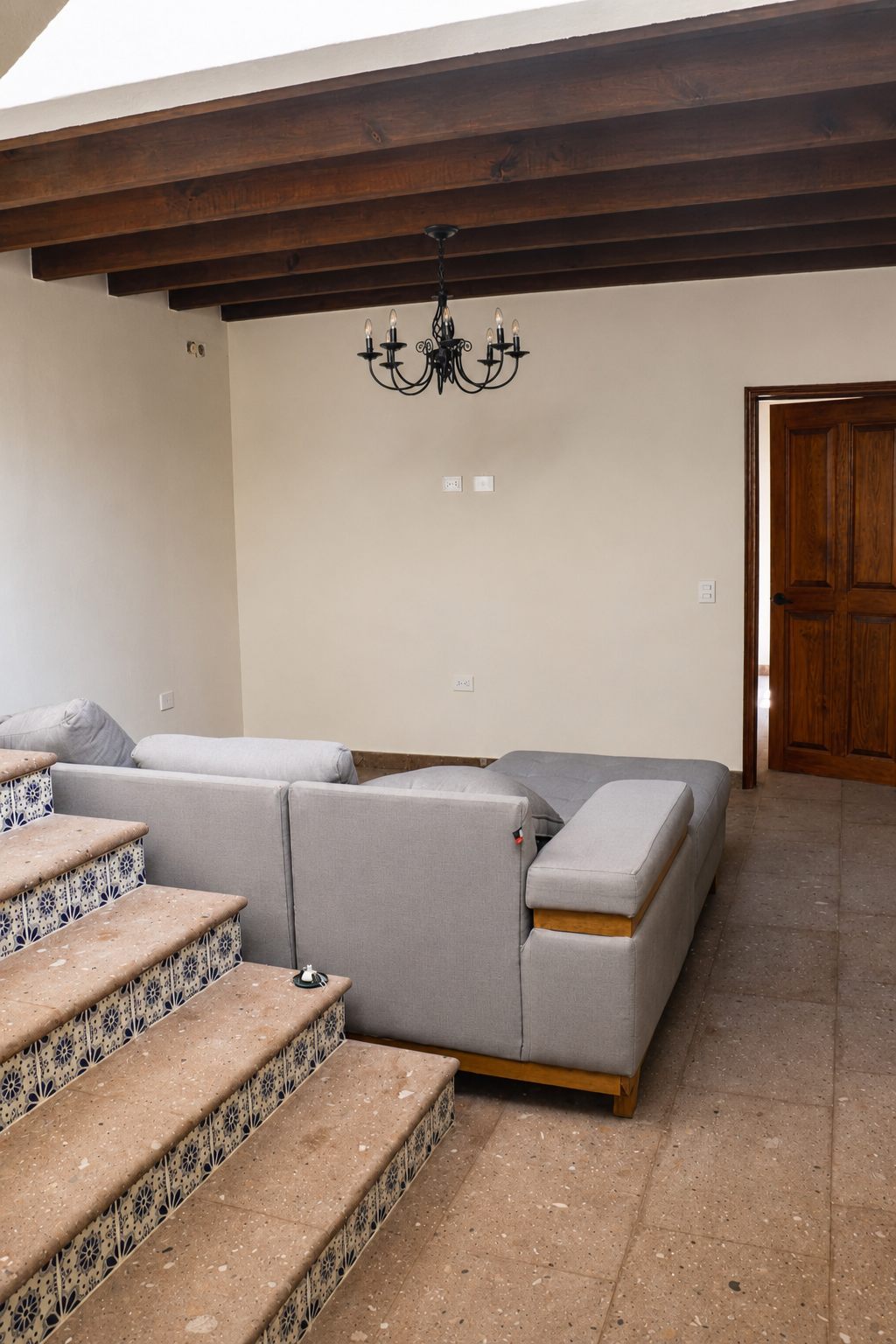 Second floor family room with sectional sofa beside the talavera staircase