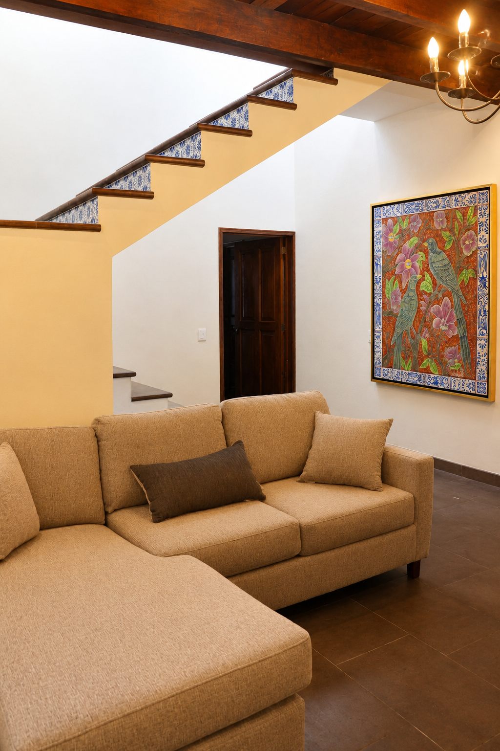 Family living room with sofa and talavera-tiled staircase