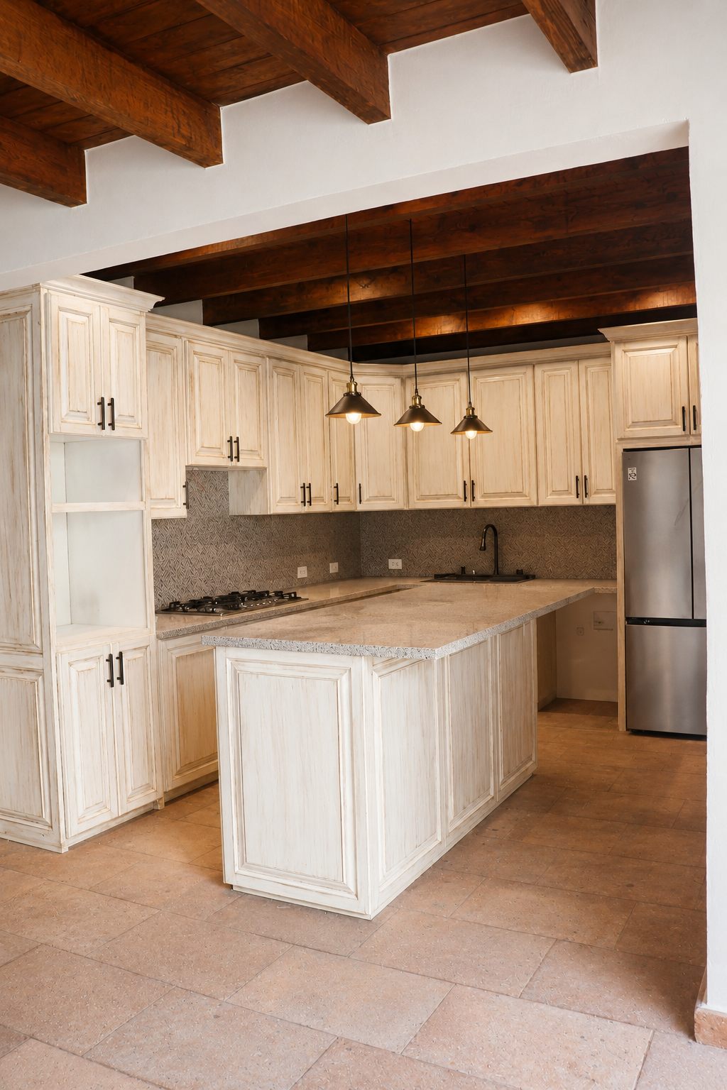 Kitchen with cream cabinetry, center island and wood beams