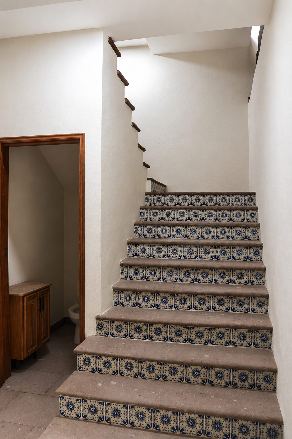 Staircase with talavera-tiled risers and wood handrail on the first floor